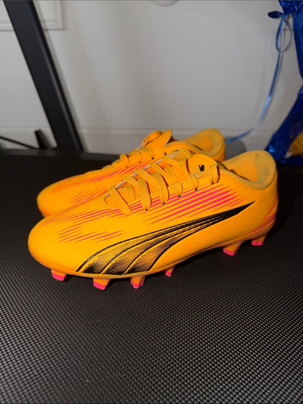 Puma Kids Orange Soccer Cleats with Pink and Black Accents